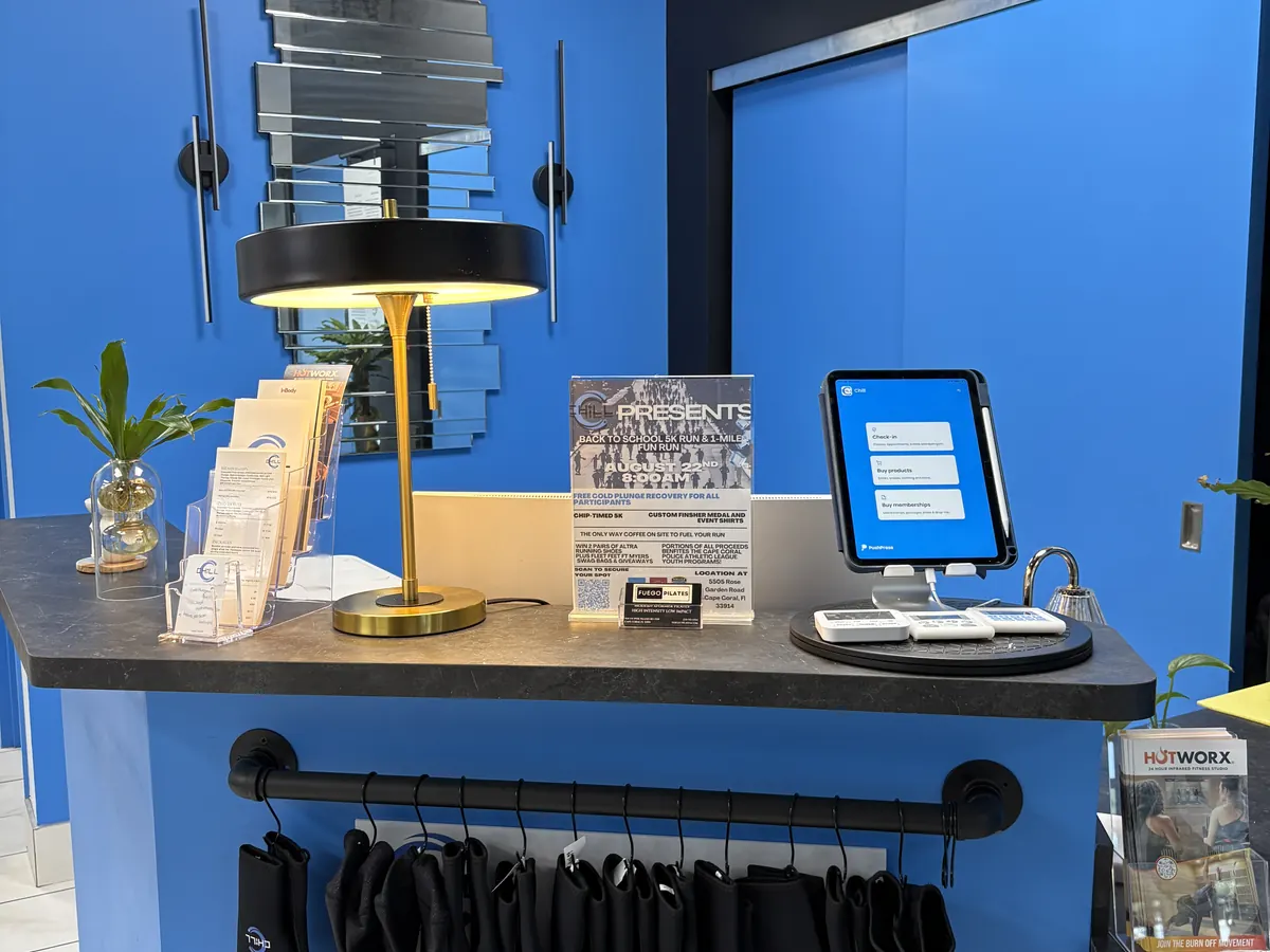CHILL reception desk with the check-in tablet and program brochures