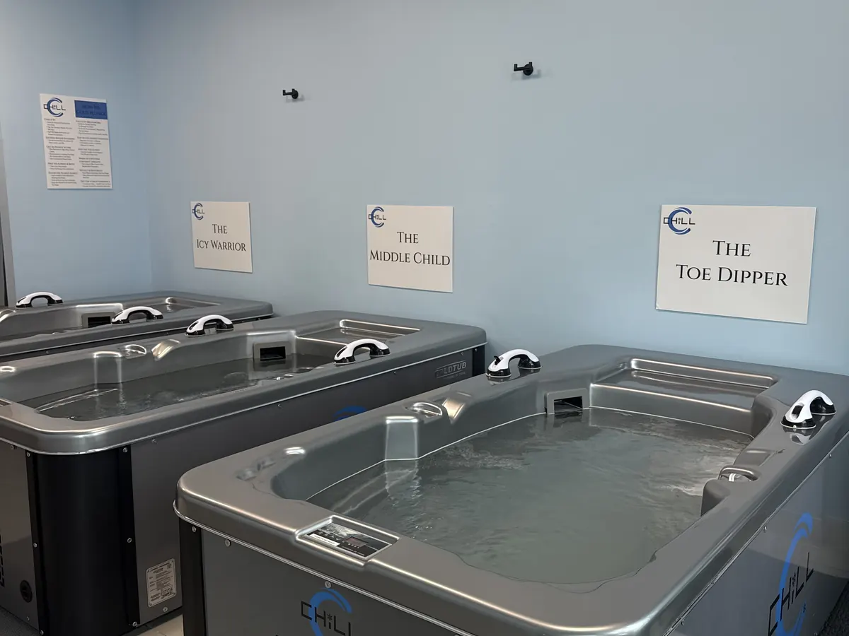 Three cold plunge tubs with tier signs: The Icy Warrior, The Middle Child, The Toe Dipper