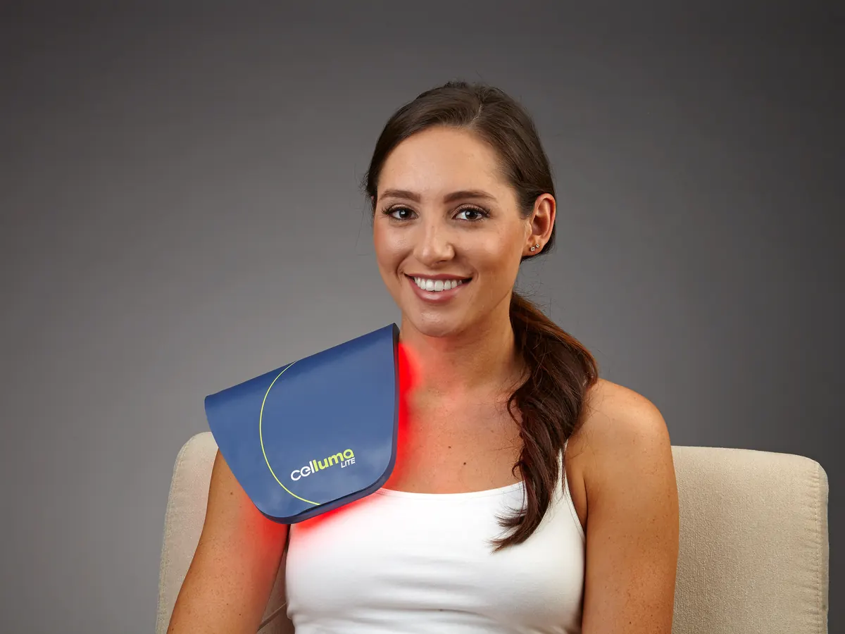 Targeted red light therapy session on a member's shoulder