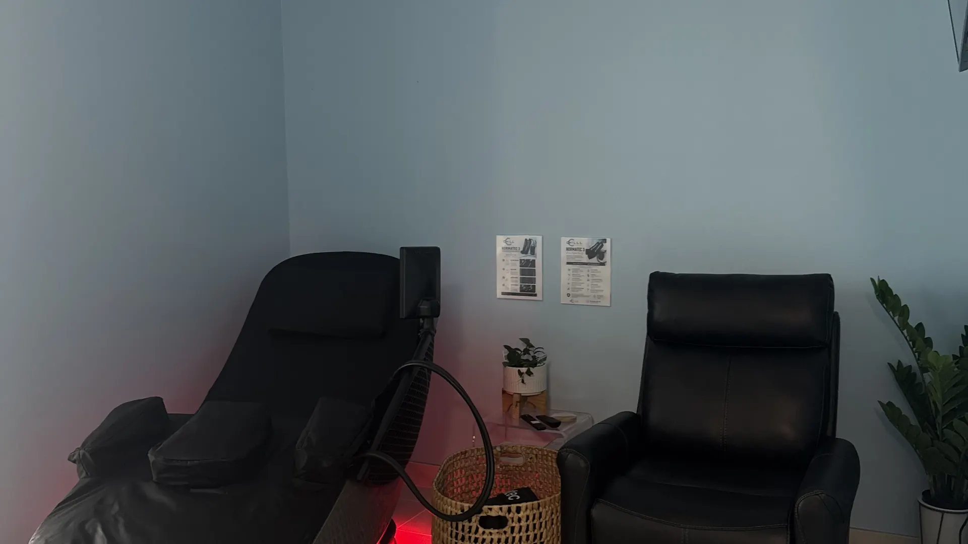 CryoLounge recliner glowing red beside a leather chair at CHILL on Chiquita